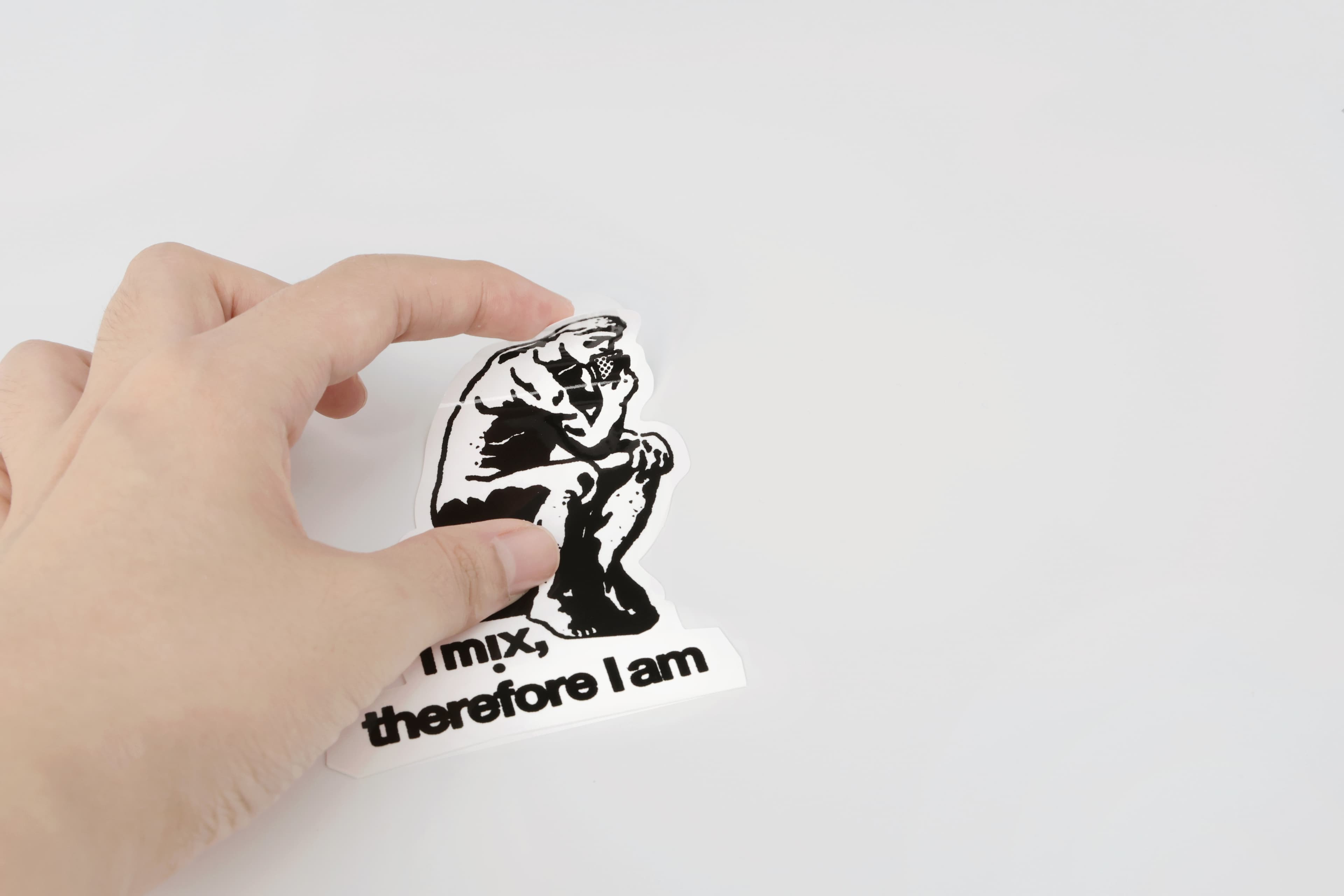 Hand holding Newmix sticker